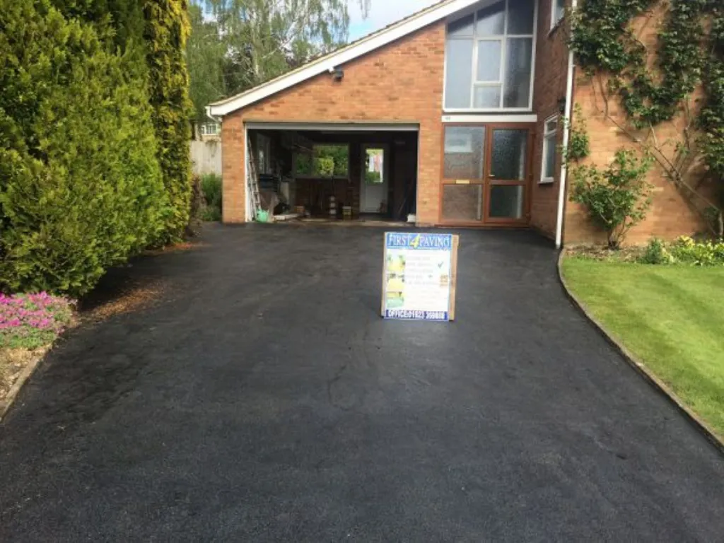 Driveways Contractors in Hertfordshire completing a smooth black tarmac driveway surface for a residential home