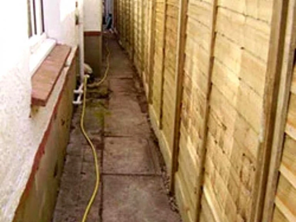 Landscaping company in Enfield side alley walkway project featuring newly installed timber garden fencing panels